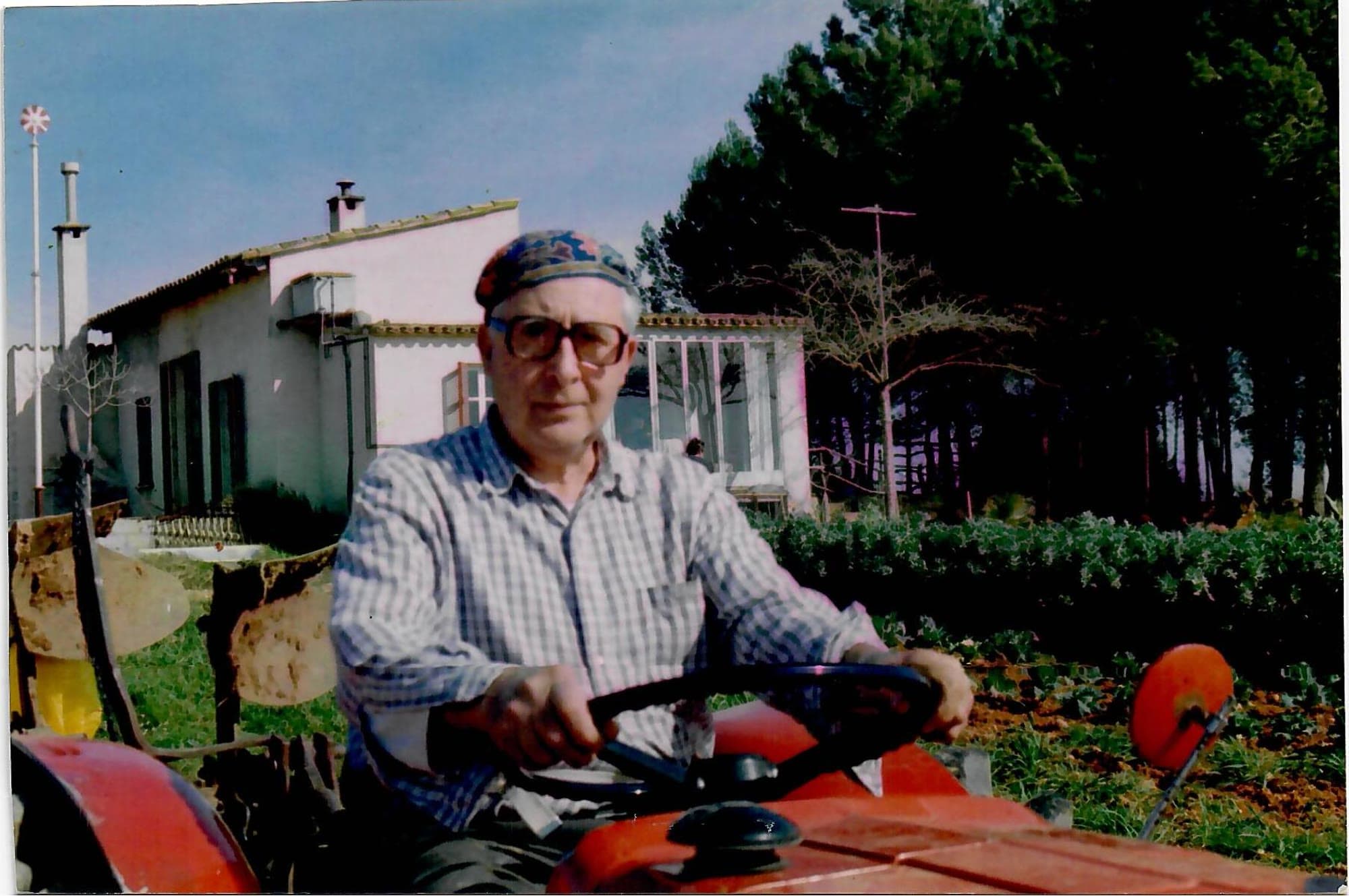 Grandfather Jaime Llabrés on the tractor in front of the finca