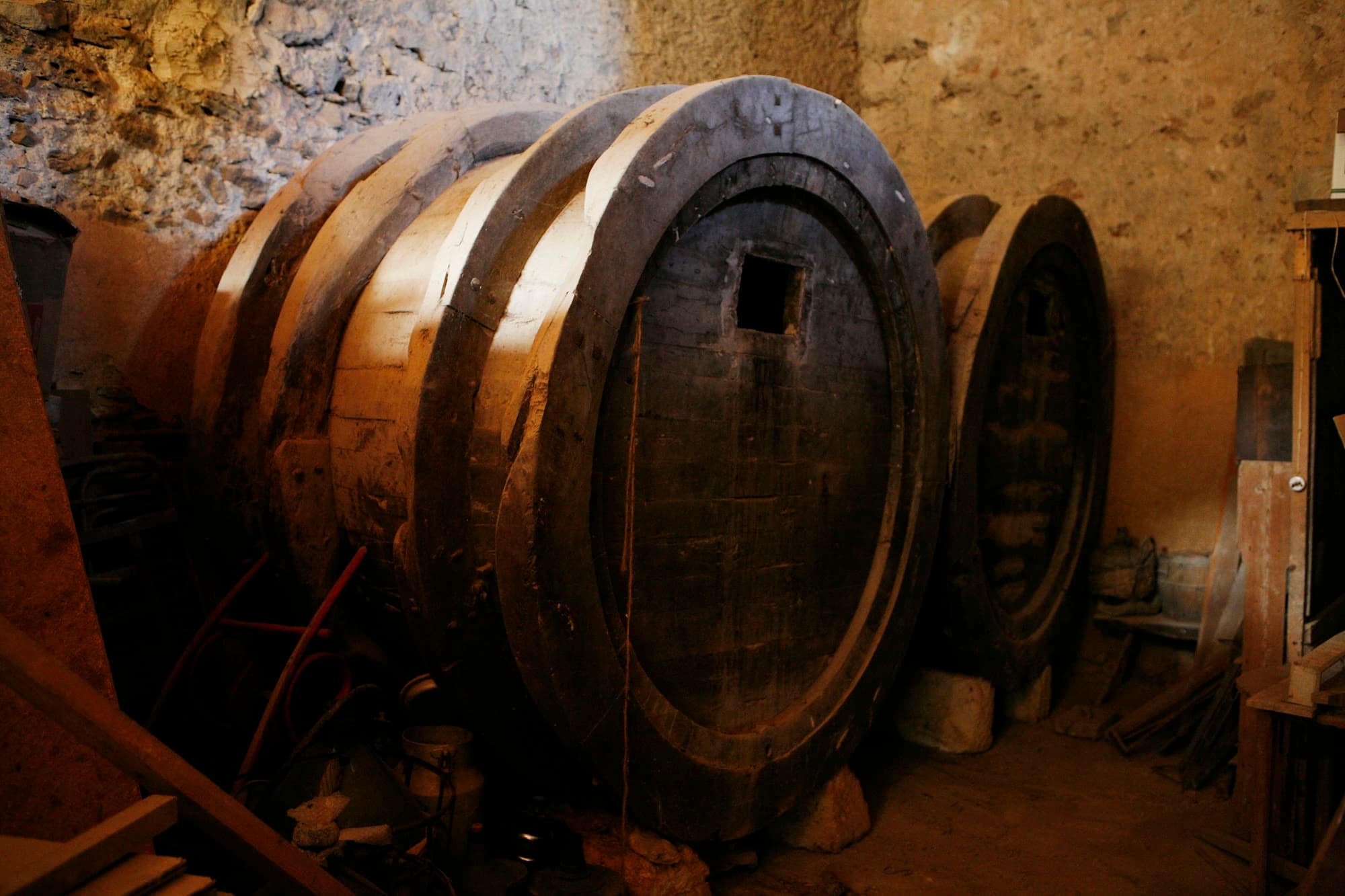 Antique oak foudres in the old stone cellar